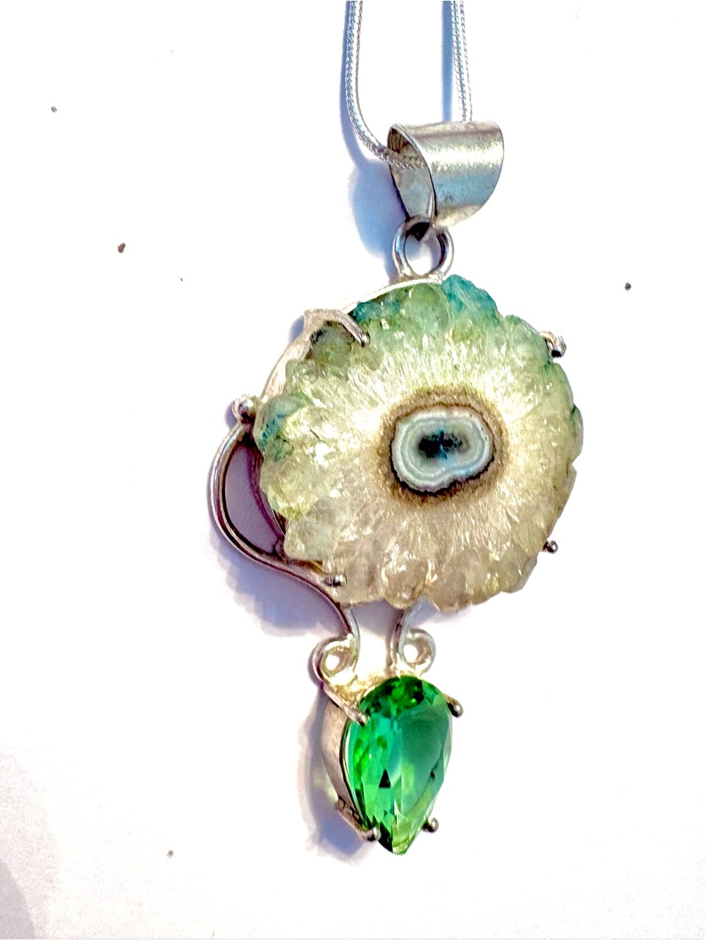 2 inch, raw, Solar Quartz  gemstone, with a green Peridot on the bottom.